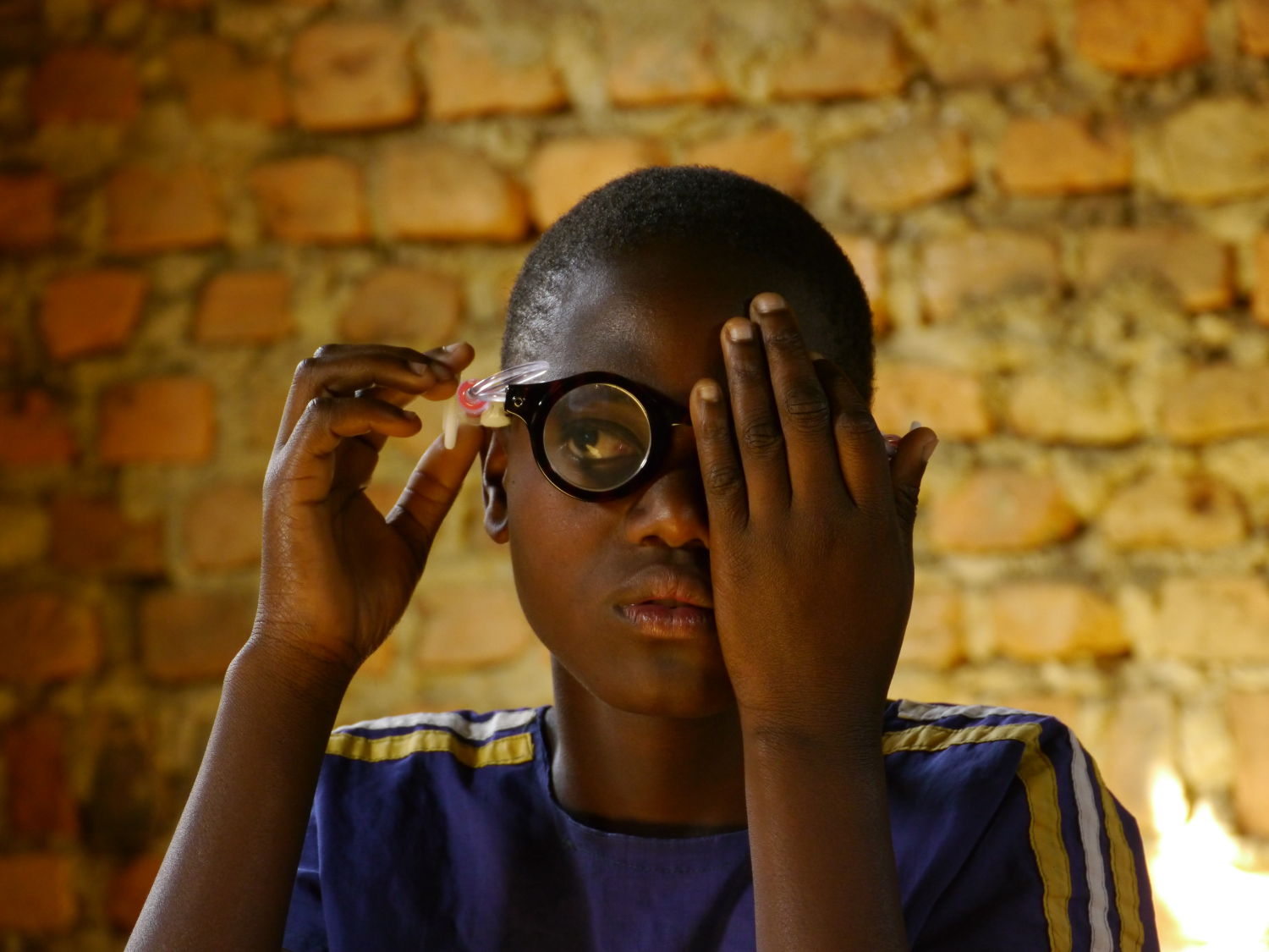 child adjusts power of lens